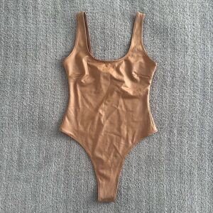skims wet jersey tank bodysuit in ochre xs